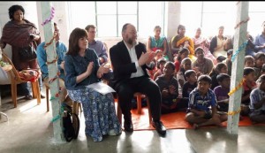 The Chief Rabbi and Valerie Mirvis enjoy a performance by children supported by the Economic Rural Development Society 